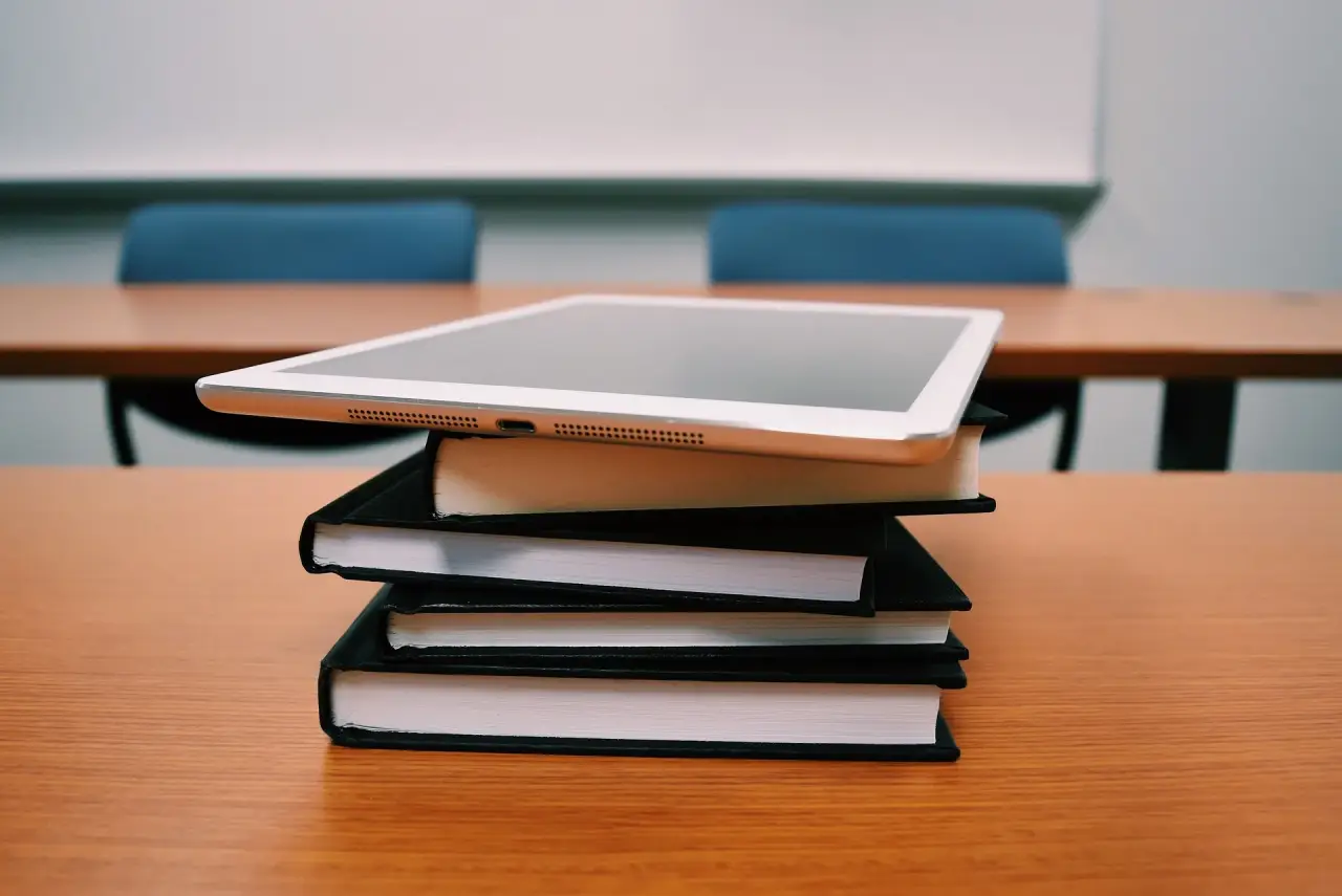 Un tablet e dei libri scolastici