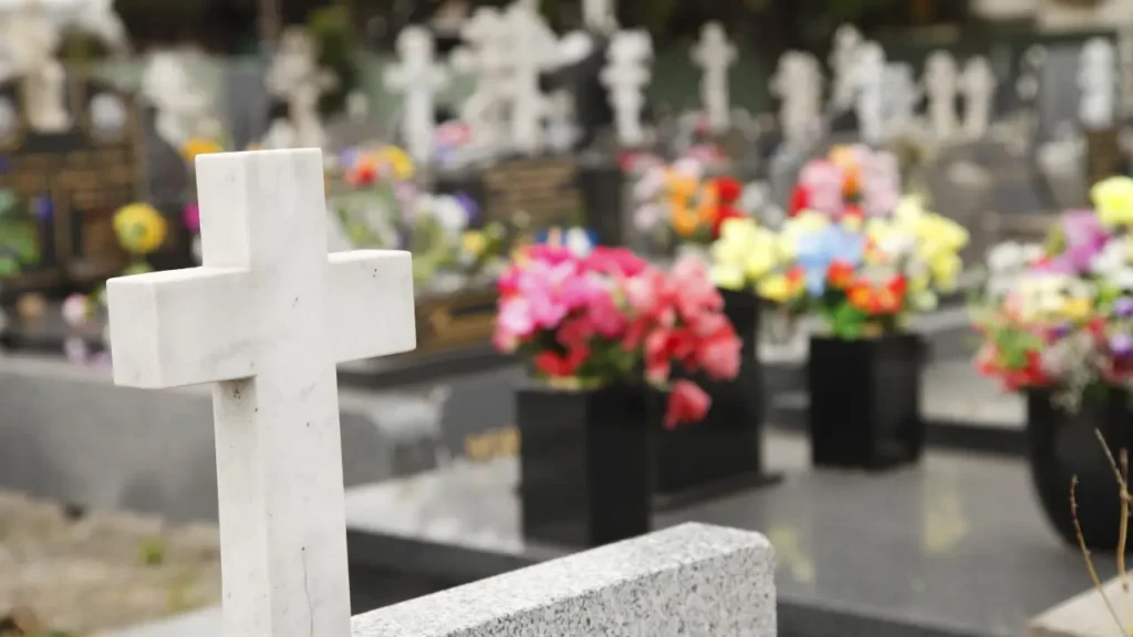 primopiano di una croce su una tomba al cimitero